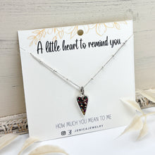 Necklace with a heart-shaped pendant on a card with text that says "A little heart to remind you how much you mean to me."