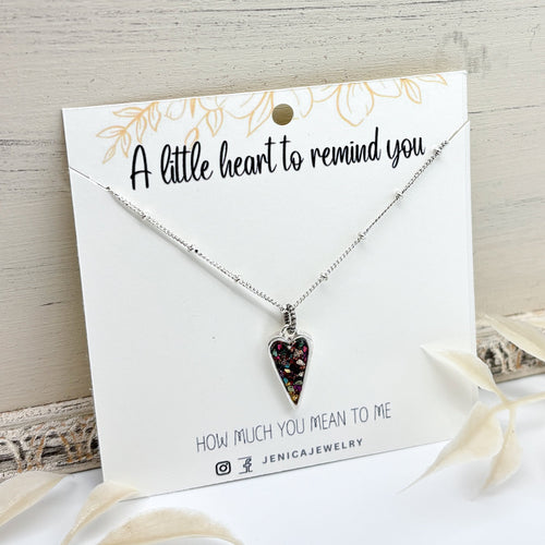Necklace with a heart-shaped pendant on a card with text that says 