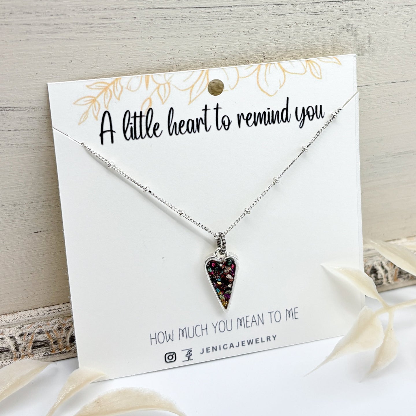 Necklace with a heart-shaped pendant on a card with text that says 