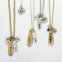 Four handmade charm necklaces in silver and gold with personalized name bars, initial discs, and birthstone charms displayed on a white background. Examples include family, faith, yaya, gigi, and grandma designs