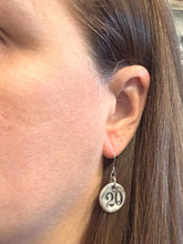 Close up of the number earring on. Hangs just under the jaw line.