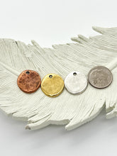 Round Charms in 3 finishes next to a dime to show its about the same size. Copper, gold & silver.