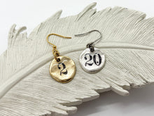 Shows a single earring in the finish of gold and silver