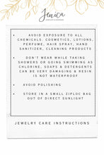 An informational jewelry care card featuring a minimalist design with gold floral accents and the "Jenica Jewelry & Designs" logo. The card lists essential care instructions: avoid exposure to chemicals like lotions, perfume, and cleaning products; do not wear while showering or swimming, as soaps and chlorine can damage resin, which is not waterproof; avoid polishing the jewelry; and store in a small airtight bag out of direct sunlight to maintain the quality and longevity of each pie