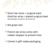 An informational graphic with gold heart bullet points and botanical line art. The text explains that silver ear wires are surgical steel and gold wires are plated surgical steel, both hypoallergenic. It notes there is "NO green skin," French ear wires include rubber stoppers, and all items come in gift-ready packaging