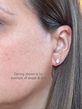 Side view profile of a model wearing a tiny white teardrop stud earring to demonstrate scale and fit on the ear lobe. Text overlay reads "Earring shown is for example of shape & size." This sizing reference image helps visualize the small, minimalist look of these dainty resin earrings. Perfect everyday earrings and handmade gifts for her.