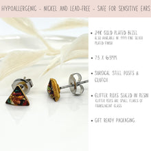 Infographic for geometric triangle stud earrings showing product details. Text highlights hypoallergenic, nickel and lead-free jewelry safe for sensitive ears. Features a 24K gold plated bezel (also available in .999 fine silver plated), surgical steel posts, 7.3 x 6.3mm sizing, and glitter roxs sealed in resin. Mentions gift ready packaging. A close-up photo shows a pair of colorful triangle post earrings with metallic foil inlay and silver butterfly backs on a white surface.