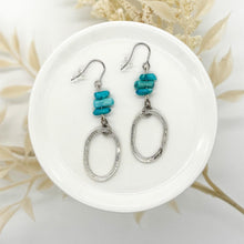 Blue turquoise chip and hammered silver oval drop earrings. These lightweight, geometric dangle earrings feature natural stone elements and a rustic, brushed metal finish, perfect for a modern boho jewelry look.