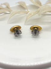 Back view of handmade gold marquise stud earrings to display the backing and hardware. The image highlights the secure surgical steel post and butterfly clutch backing attached to the textured gold frames, resting on a clean white ceramic dish.