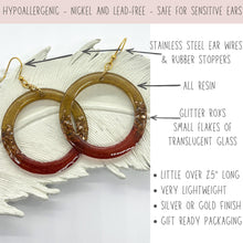 A pair of hoop earrings with gold-colored ear wires. The earrings are made of resin and feature glitter roxs (small flakes of translucent glass). The earrings are approximately 2.5 inches long and are lightweight. The text on the image says they are hypoallergenic and safe for sensitive ears. They come in silver or gold ear wire options.
